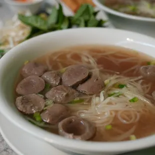 a bowl of soup with meat and noodles
