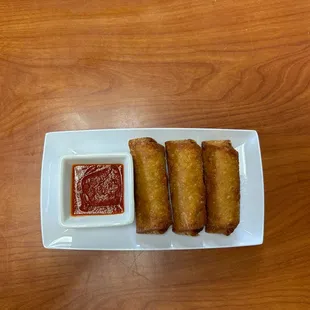 a plate of food with dipping sauce