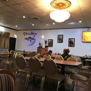 people sitting at tables in a restaurant