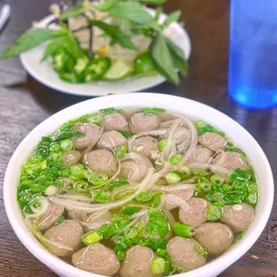 a bowl of soup with meatballs and broccoli