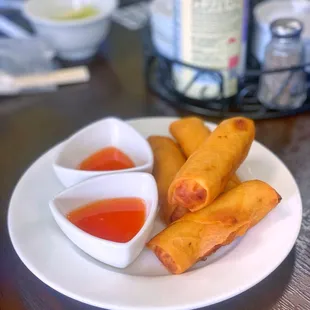 a plate of food with dipping sauces
