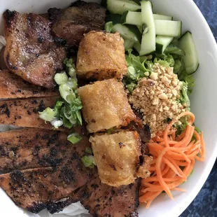 Grilled pork vermicelli with egg roll.
