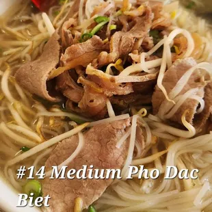 a bowl of noodles with meat and vegetables