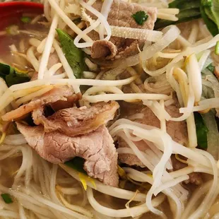 a bowl of noodles with meat and vegetables