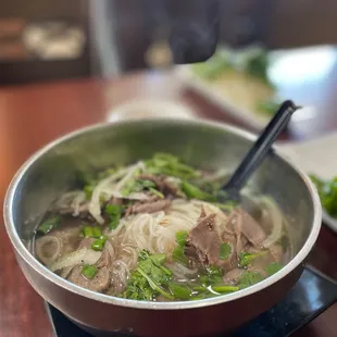 a bowl of beef and noodles