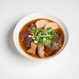 a bowl of soup with meat and vegetables