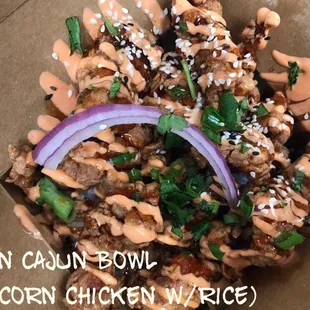 Seasoned popcorn chicken with signature teriyaki and orange sauce over white rice