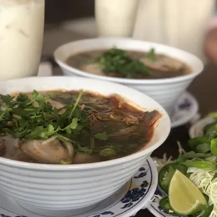 two bowls of soup and a salad