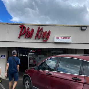 a man walking out of the front of a restaurant