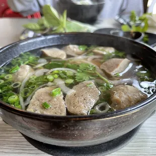 a bowl of soup with meat and vegetables