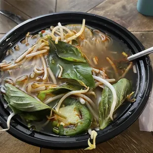 a bowl of soup with noodles and vegetables