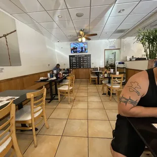 a man sitting at a table in a restaurant