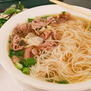 a bowl of noodles with meat and vegetables