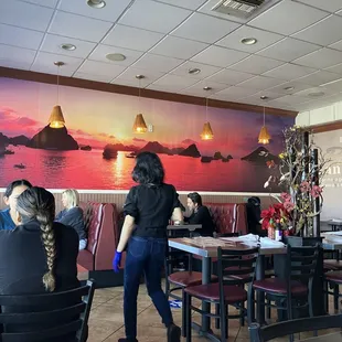 a woman standing in a restaurant