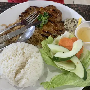 Grilled beef short ribs with rice, cooked egg, fish sauce, and usual fixins with the vegetables.