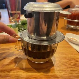 a woman's hand reaching for a mixing bowl