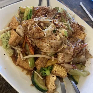Flat rice noodles dish from the vegan menu with tofu and veggies