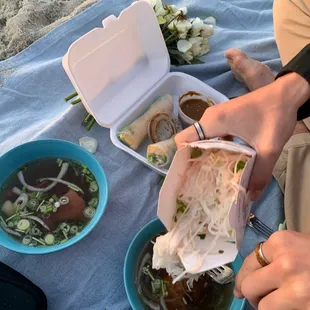 a person eating a meal on the beach