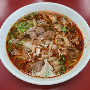 a bowl of soup on a red table