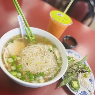 a bowl of soup with chopsticks