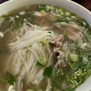 a bowl of soup with meat and vegetables