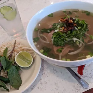 Rare steak pho topped with fried onion