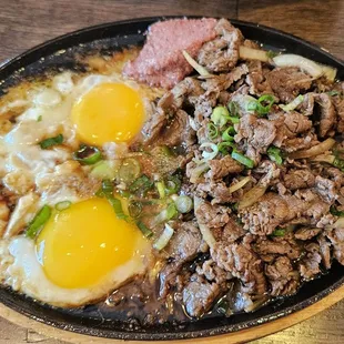 Yummy filet mignon on sizzling platter