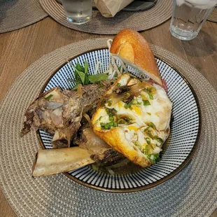 Beef Ribs with egg baguette and the fixins, this was ordered to go and replated at home