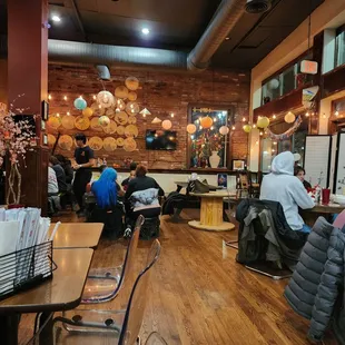 people sitting at tables in a restaurant