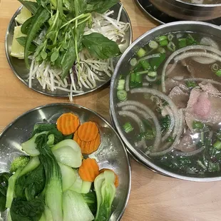 Rare steak pho with a side of veggies