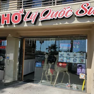 a storefront with mannequins in the window