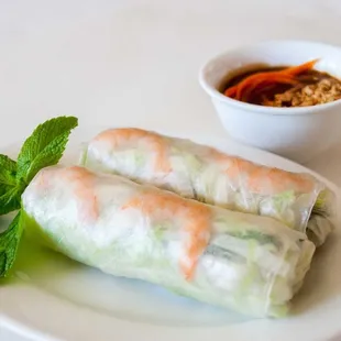a plate of food with a bowl of dipping sauce