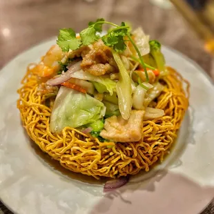 a plate of noodles with meat and vegetables