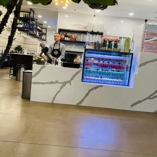a man behind a counter in a restaurant