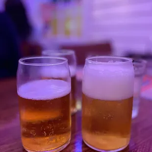 two glasses of beer on a table