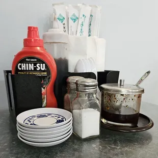 a table with dishes and condiments