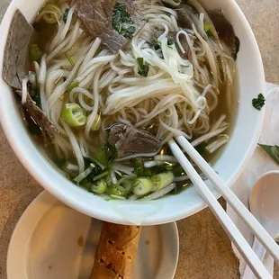 Lunch special 10.99 beef noodle soup w eggroll.