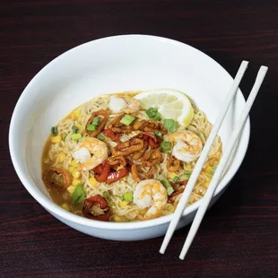 a bowl of noodles and chopsticks