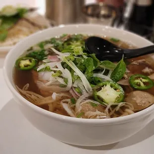  bowl of pho noodle with meat and vegetables