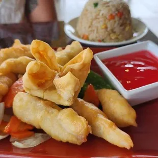 a plate of food with dipping sauce