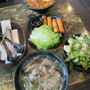 P10. Well Done Steak and Spicy Beef Noodle Soup (Bun Bo Hue) A1. Crispy Pork Egg Rolls