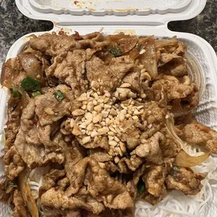 a tray of noodles and meat