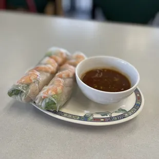 a plate of food with dipping sauce