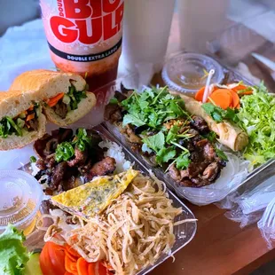 a sandwich, salad, and drink on a table