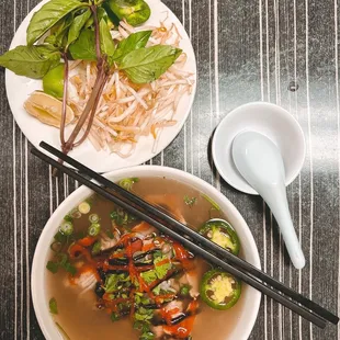 a bowl of soup and chopsticks