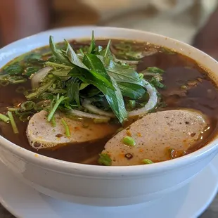 a bowl of soup and chopsticks
