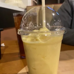 a drink in a plastic cup with a straw