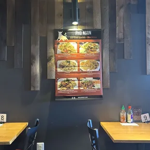 two tables and a menu on the wall