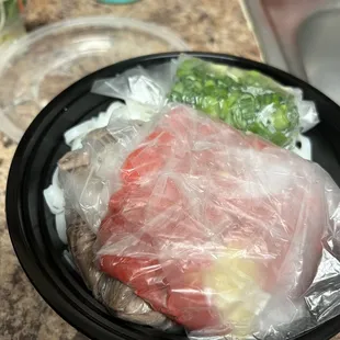 a plate of food wrapped in plastic