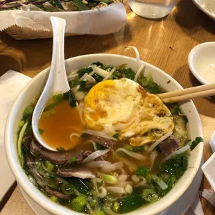 Fried egg with beef tenderloin pho.